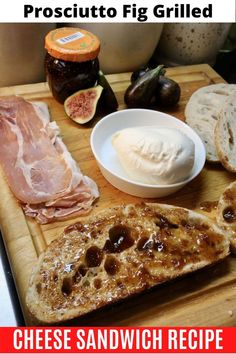 a wooden cutting board topped with cheese and meats next to other foods on top of it