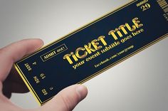 a person holding up a ticket that says ticketstuf in gold lettering on it