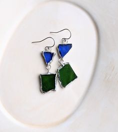 These earrings we made using stained glass techniques with copper foil and lead-free solder.  They are blue and green glass together on sterling silver ear hooks.  They measure 2 inches or 48mm in length.    Buy them today! To see more of my designs, please visit: kateemarie.etsy.com Stained Glass Earrings, Stained Glass Jewelry, Jewellery Inspiration, Copper Foil, Earrings Minimalist, Glass Earrings, Minimalist Earrings, Glass Jewelry, Earrings Silver