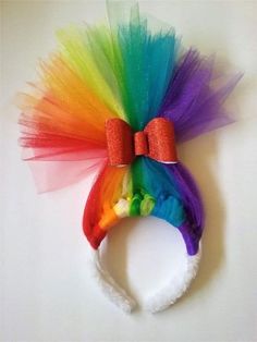 there is a rainbow colored headband with a bow at the top and a white background