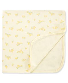 a baby blanket with yellow and blue butterflies on it, folded up to the side