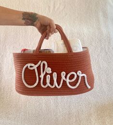 a person holding a brown basket with the word clever written on it