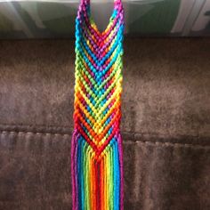 a multicolored beaded necklace hanging on a couch