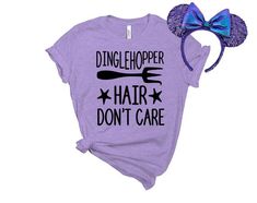 a purple shirt that says dingle shopper hair don't care with a blue bow