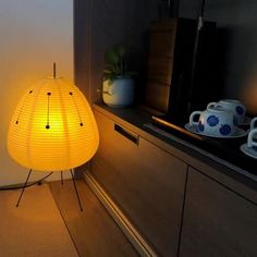 a yellow lamp sitting on top of a wooden table