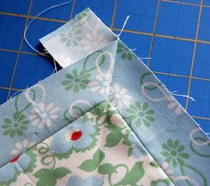 two pieces of fabric sitting on top of a cutting board