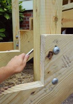 a person is working on some wood with a screwdriver in their left hand