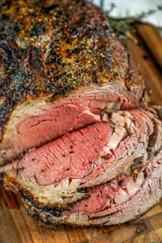 a large piece of meat sitting on top of a wooden cutting board