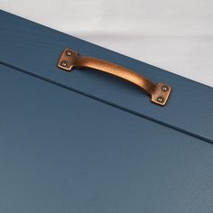 a blue suitcase with a wooden handle on it