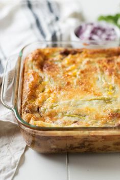 a casserole dish with broccoli and cheese in it on a table