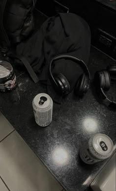 a counter with headphones and other items sitting on it's side by side