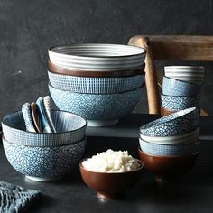 several bowls with spoons and plates in them on a table