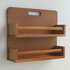 a wooden cutting board with two shelves attached to the wall