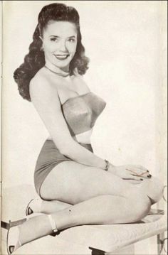 a black and white photo of a woman in a bathing suit