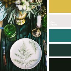 a table topped with green plates and silverware