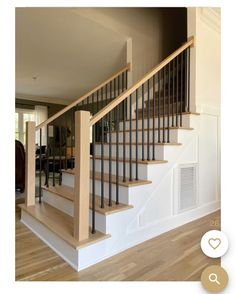 a wooden stair case next to a hard wood floor