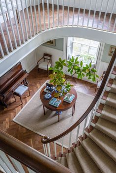 a living room filled with furniture next to a stair case