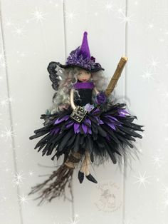 a doll is dressed in black and purple