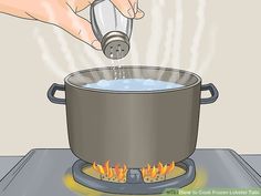 a person is pouring water into a pot on top of a stove with flames in it