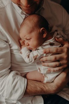 a man holding a baby in his arms