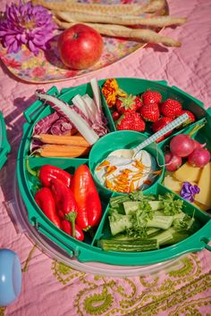 a green tray filled with lots of different types of food