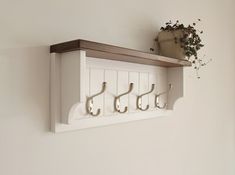 three hooks are attached to a white shelf