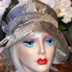 sage/taupe/light pewter  100% Dupioni Silk Cloche PLEASE MEASURE HEAD  My hats are so Soft and foldable. Made to be folded and put it in your purse.                                Step into the Gatsby Era glamour world of the Roaring 20's  accessories with this stunning 1920's cloche hat. Inspired by the iconic styles of the Jazz Age, this handcrafted accessory is the perfect addition to any vintage lover's  flapper style wardrobe.                         Crafted with meticulous attention to detail, the cloche hat features a classic bell-shaped silhouette and a sophisticated brim that beautifully frames the face. Made from high-quality materials, this hat will not only add a touch of elegance to any outfit.                    Whether you're attending a Gatsby-themed party or simply want to Roaring 20s Accessories, Light Pewter, Gatsby Hat, Bespoke Hats, Gatsby Themed Party, Flapper Hat, Cloche Hats, Glamour World, The Jazz Age