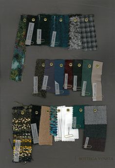 there are many different colors of fabric on the table together, and each has a price tag attached to it