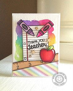 a thank you teacher card with an apple and pencils on the front, next to a ruler