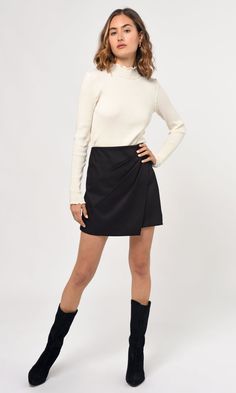 This wrap mini skirt is expertly designed with pleats that ensure comfort and a perfect silhouette. The satin material provides a luxe look and feel. Mini skirt Pleated Length: 16 1/2" Across waist: 13 1/2" Self: 100% Polyester Lining: 100% Polyester Hand wash with similar colors. Dry flat and iron low. Model is wearing a size small Style #: G237S9304 Luxury Casual Pleated Skirt Bottoms, Luxury Black Cotton Skirt, Luxury Lined Mini Pleated Skirt, Luxury Elegant Black Knit Top, Luxury Black Mini Length Bottoms, Luxury Casual Black Skirt, Luxury Black Mini-length Bottoms, Luxury Casual Skirt With Pleated Waist, Luxury Black Relaxed Wrap Skirt