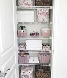 an organized closet with baskets and towels