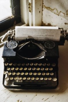 an old fashioned typewriter sitting on top of a table