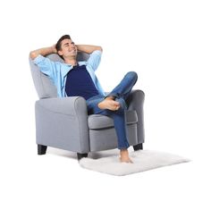 a man sitting in a recliner with his feet up on the back of the chair