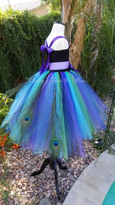 a dress made out of tulle and peacock feathers