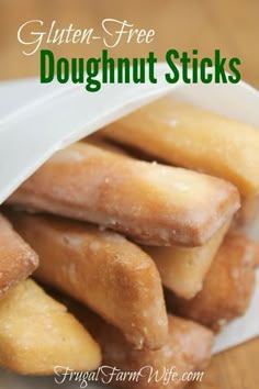 gluten - free doughnut sticks piled up in a paper bag