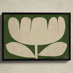 a white flower on a green background is framed in black and white wood with a dark border