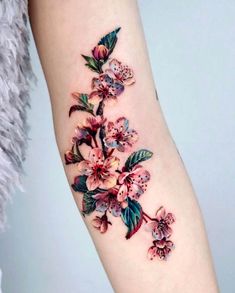 a woman's arm with flowers on it