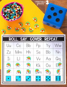 roll say cover repeat game with dices on the table and rainbow letters in front