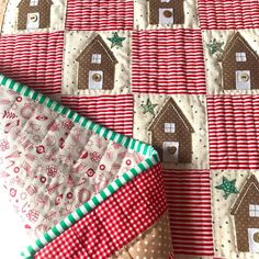 a quilted table runner with gingerbread houses on it