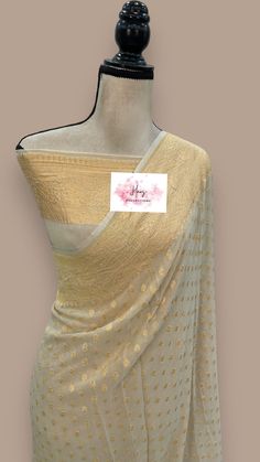 This pure georgette banarasi saree is certified by Silk mark, ensuring its authenticity. Made from high-quality materials, this saree is soft and comfortable to wear. With its intricate benarasi design, it adds a touch of elegance to any occasion. Elevate your style with this exquisite piece. fall & pico done Blouse: 36 to 40 Adjustable Size stitched blouse Designer Georgette Dupatta With Zari Work, Gold Designer Saree In Traditional Drape, Designer Gold Saree With Zari Work, Designer Georgette Saree, Designer Georgette Saree With Dupatta, Designer Georgette Blouse With Traditional Drape, Designer Georgette Dupatta, Designer Georgette Blouse Piece For Festivals, Designer Georgette Saree With Unstitched Blouse