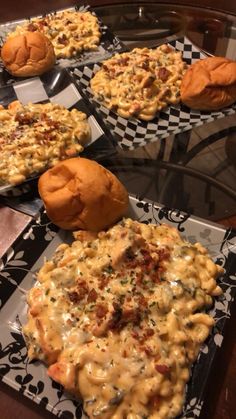 some food is sitting on plates on a table with black and white checkered napkins