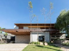 a modern house with an open roof and brick walkway