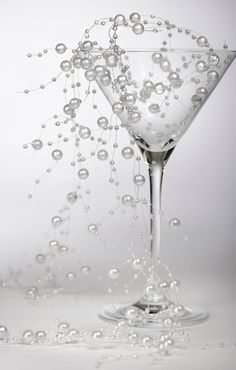 a martini glass filled with water and bubbles