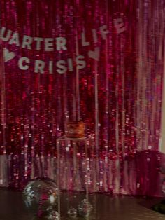 there is a red curtain that says water life and crisss on it in front of a disco ball