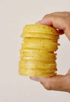 a hand holding a stack of potato chips