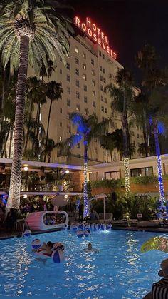 people are relaxing in the pool at night near hotel roostelu, las vegas