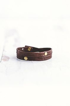 Made for the true warrior, our Double Warrior wrap is a narrow leather bracelet that wraps around the wrist twice and features two flat antique brass rivet accents. **Contents** * Lambskin leather, antique brass hardware * Button clasp closure * Handmade **Care/Import** * Made in the USA **Dimensions** * Adjustable to fit wrist sizes 6.5”-8” | Giving Bracelets Antique Brass Double Warrior Wrap Bracelet at Free People in Brown Leather Jewelry With Rivets As A Gift, Leather Jewelry With Rivets For Gifts, Adjustable Leather Bracelet With Rivets For Gift, Vintage Leather Bracelet For Everyday, Adjustable Riveted Leather Bracelet Gift, Adjustable Leather Bracelet With Rivets, Vintage Brown Leather Bracelet For Everyday, Adjustable Brown Leather Bracelet With Brass Hardware, Brown Rectangular Leather Strap Bracelet