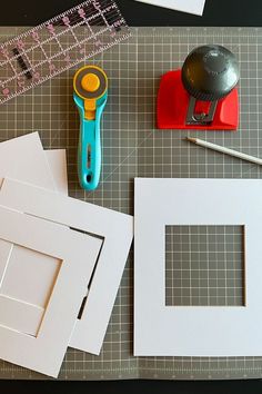 some crafting supplies are laid out on a table with scissors, tape and paper