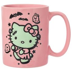 a pink hello kitty mug with bats and stars on it