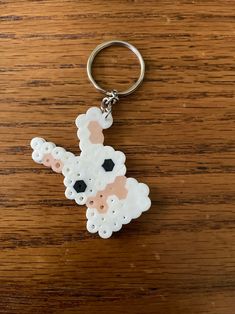 a keychain with a sheep design on it